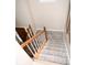 Carpeted staircase with white risers and stained wood handrail at 9130 Charlton Pl, Douglasville, GA 30135