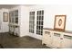 Sunroom featuring tile flooring, white walls, with a buffet and console table, and ample natural light through large windows at 9130 Charlton Pl, Douglasville, GA 30135