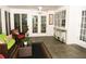 Bright sunroom with tile floors, white walls, and large windows providing natural light, with comfortable seating and stylish decor at 9130 Charlton Pl, Douglasville, GA 30135