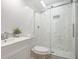 A bathroom with marble tile shower, and a white vanity at 2358 Armand Ne Rd, Atlanta, GA 30324