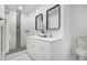 Bathroom with a double vanity, modern mirrors, tiled shower, and tile flooring at 2358 Armand Ne Rd, Atlanta, GA 30324