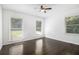Bright bedroom featuring beautiful hardwood floors, ceiling fan and multiple windows at 2358 Armand Ne Rd, Atlanta, GA 30324