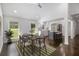 Bright dining room featuring hardwood floors, a modern ceiling fan, and views into the updated kitchen at 2358 Armand Ne Rd, Atlanta, GA 30324