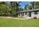Charming home with a well-manicured lawn and a curved walkway leading to the front door at 2358 Armand Ne Rd, Atlanta, GA 30324