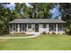 Charming, freshly painted single-story home with black shutters, landscaping, walkway, and inviting front entry at 2358 Armand Ne Rd, Atlanta, GA 30324