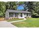 Charming, freshly painted single-story home with black shutters, landscaping, and an inviting front yard at 2358 Armand Ne Rd, Atlanta, GA 30324