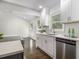 Bright open kitchen with white cabinets, stainless steel appliances, and hardwood floors at 2358 Armand Ne Rd, Atlanta, GA 30324
