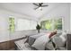 Serene bedroom with large windows, ceiling fan, and a neutral color palette offers relaxing retreat at 2358 Armand Ne Rd, Atlanta, GA 30324
