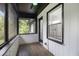 A screened porch features a ceiling fan, hardwood floor, and white-painted brick at 2358 Armand Ne Rd, Atlanta, GA 30324