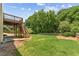 Spacious backyard showcasing lawn, patio area, and elevated wooden deck, ideal for entertaining at 2667 Hampton Park Dr, Marietta, GA 30062