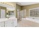 Primary bathroom with double sinks, a soaking tub, and glass shower at 2667 Hampton Park Dr, Marietta, GA 30062