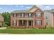 Charming two-story brick home with black shutters, a covered porch, and manicured lawn at 2667 Hampton Park Dr, Marietta, GA 30062