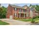 Charming brick home with a well-manicured lawn, inviting front porch, and attached garage at 2667 Hampton Park Dr, Marietta, GA 30062