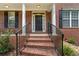 Inviting front door with brick steps, leading up to a covered porch with classic columns at 2667 Hampton Park Dr, Marietta, GA 30062