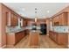 Stylish kitchen boasts wood cabinets, granite countertops, an island, and modern black appliances at 2667 Hampton Park Dr, Marietta, GA 30062