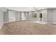Spacious living room with built-in shelving, large windows, and neutral carpet at 2667 Hampton Park Dr, Marietta, GA 30062