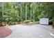 Backyard with a patio area, storage shed, and mature trees providing privacy at 2800 Mornington Nw Dr, Atlanta, GA 30327