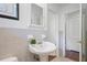 Bathroom featuring a pedestal sink, classic tile, and a decorative mirror at 2800 Mornington Nw Dr, Atlanta, GA 30327