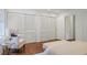 Well-lit bedroom featuring hardwood floors, plush chair, and closets at 2800 Mornington Nw Dr, Atlanta, GA 30327