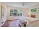 Bright bedroom with large windows overlooking lush greenery, hardwood floors, and white walls at 2800 Mornington Nw Dr, Atlanta, GA 30327