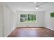 Spacious bedroom with hardwood floors, and a large window with a view of the trees at 2800 Mornington Nw Dr, Atlanta, GA 30327