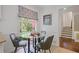 Cozy breakfast nook with round glass table, chairs, and window with patterned shade at 2800 Mornington Nw Dr, Atlanta, GA 30327