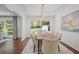 Bright dining room features modern light fixture and views to the wooded backyard at 2800 Mornington Nw Dr, Atlanta, GA 30327