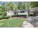 Charming single-story home with white painted brick, manicured landscaping, and covered parking at 2800 Mornington Nw Dr, Atlanta, GA 30327