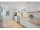 Bright kitchen with white cabinetry, stainless steel appliances, and tile flooring at 2800 Mornington Nw Dr, Atlanta, GA 30327