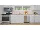 Well-lit kitchen with stainless steel appliances, ample cabinet space, and bright countertops at 2800 Mornington Nw Dr, Atlanta, GA 30327