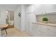 Kitchen with white cabinets, neutral countertops, tiled floor, and view of staircase at 2800 Mornington Nw Dr, Atlanta, GA 30327
