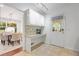Bright mud room with built-in desk, storage cabinets, and stylish wallpaper, adjacent to dining room at 2800 Mornington Nw Dr, Atlanta, GA 30327