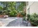 Spacious outdoor patio with stone flooring, string lights, lush landscaping and room for entertaining at 2800 Mornington Nw Dr, Atlanta, GA 30327