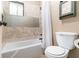 Bathroom with a tiled tub and shower combination with a framed medicine cabinet above the toilet at 3251 Abbeywood Dr, Decatur, GA 30034