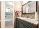 Stylish bathroom with a green vanity, granite countertop, and a view into the shower/tub room at 3251 Abbeywood Dr, Decatur, GA 30034