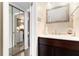 Bathroom features a dark vanity, large mirror, and a peek into the kitchen and laundry area at 3251 Abbeywood Dr, Decatur, GA 30034