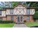 A brick townhome with Tudor-style accents, well-manicured lawns, and inviting curb appeal at 3251 Abbeywood Dr, Decatur, GA 30034