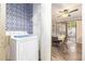 Laundry room featuring a laundry machine, shelving, and access to dining room at 3251 Abbeywood Dr, Decatur, GA 30034