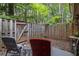 Backyard patio with two chairs and lush greenery of trees in the background beyond the fence at 3251 Abbeywood Dr, Decatur, GA 30034