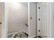 Basement stairs with a wooden handrail and steps with wood look floors leading to a white door at 3251 Abbeywood Dr, Decatur, GA 30034