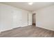 A bedroom featuring wood-look flooring and an open doorway leading to another room at 4895 Ozment Ridge Ct, Lithonia, GA 30038