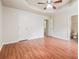 Bedroom featuring wood-look flooring, and a ceiling fan, with views to the bathroom and hall areas at 4895 Ozment Ridge Ct, Lithonia, GA 30038