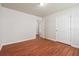 A bedroom featuring wood-look floors, a doorway and light colored walls at 4895 Ozment Ridge Ct, Lithonia, GA 30038