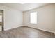 Bedroom featuring a window, light gray walls and wood-look floors at 4895 Ozment Ridge Ct, Lithonia, GA 30038