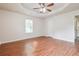 A cozy bedroom featuring hard wood floors, a ceiling fan and a window at 4895 Ozment Ridge Ct, Lithonia, GA 30038