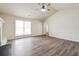 Bright, spacious living room with neutral paint, lots of natural light, and lovely hardwood floors at 4895 Ozment Ridge Ct, Lithonia, GA 30038