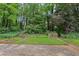 This backyard boasts lush greenery, tiered gardens, and stone accents for a serene retreat at 763 Brookwood Sw Ter, Lilburn, GA 30047