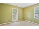 Bedroom with green walls, neutral carpet, and two windows for natural light at 763 Brookwood Sw Ter, Lilburn, GA 30047