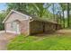 A one-story brick house featuring an attached garage, quaint windows, and a well-kept lawn at 763 Brookwood Sw Ter, Lilburn, GA 30047