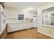 Functional kitchen with white cabinetry, wood flooring, and ample counter space for easy meal preparation at 763 Brookwood Sw Ter, Lilburn, GA 30047